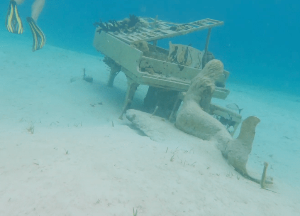 Underwater mermaid and piano sculpture